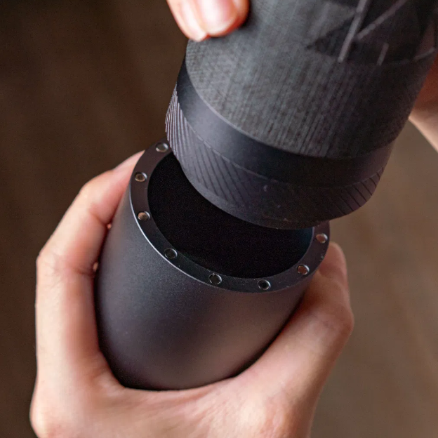 Dark grey hand grinder with wood handle. Hand grinders that are best for grinding filter and espresso beans.